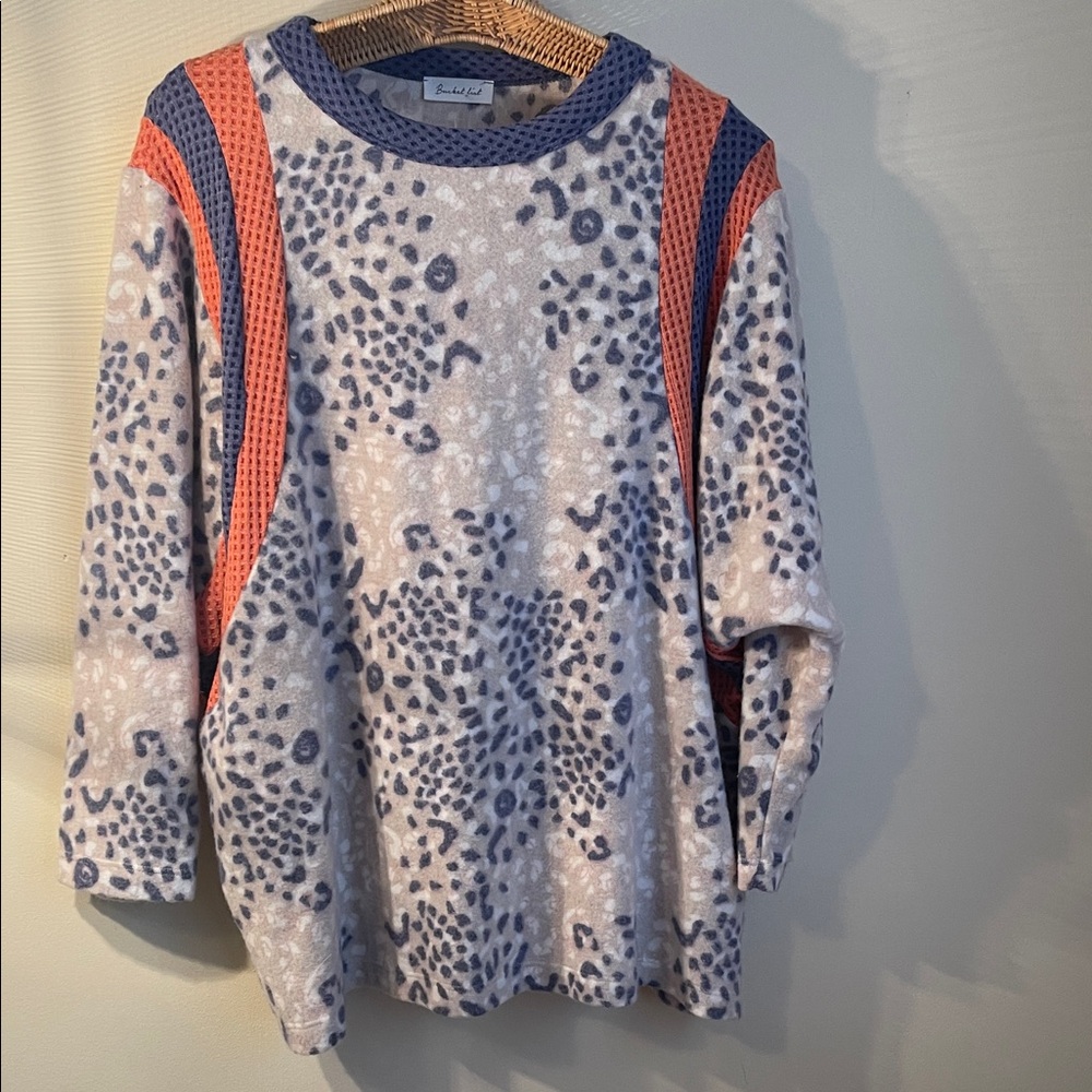 Lightweight fleece top. Print with blue/orange accents on neck and sleeves.